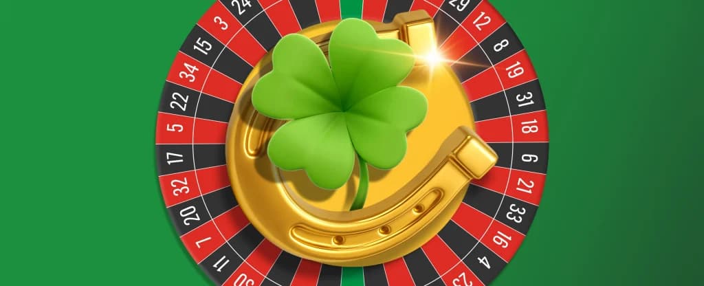 A roulette wheel with a golden horseshoe and a bright green four leaf clover placed on top on a bright green background.