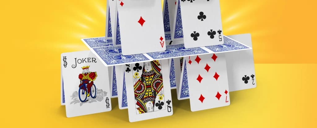 The image features a structure formed of multiple playing cards. On a yellow background.