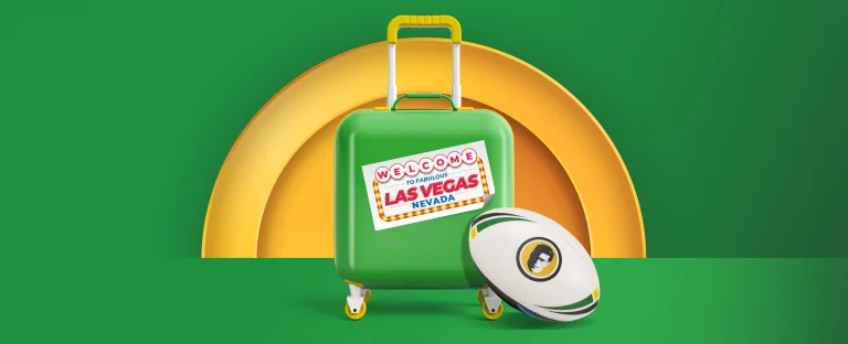 A suitcase with a sticker on it saying “Welcome to Fabulous Las Vegas Nevada” plus an NRL ball with the Joe Fortune logo on it on a green background.