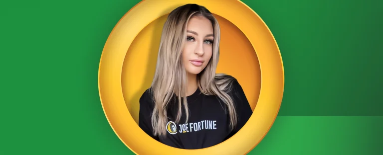 A photo of JustMaddyX wearing a Joe Fortune t-shirt on a green background.