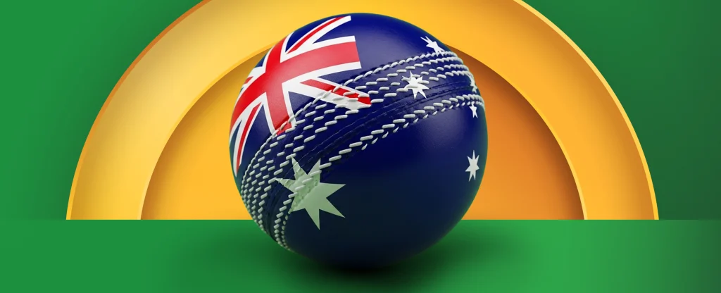 A cricket ball decorated with the Australian flag sitting on a green surface in front of a golden arc on a bright green background.
