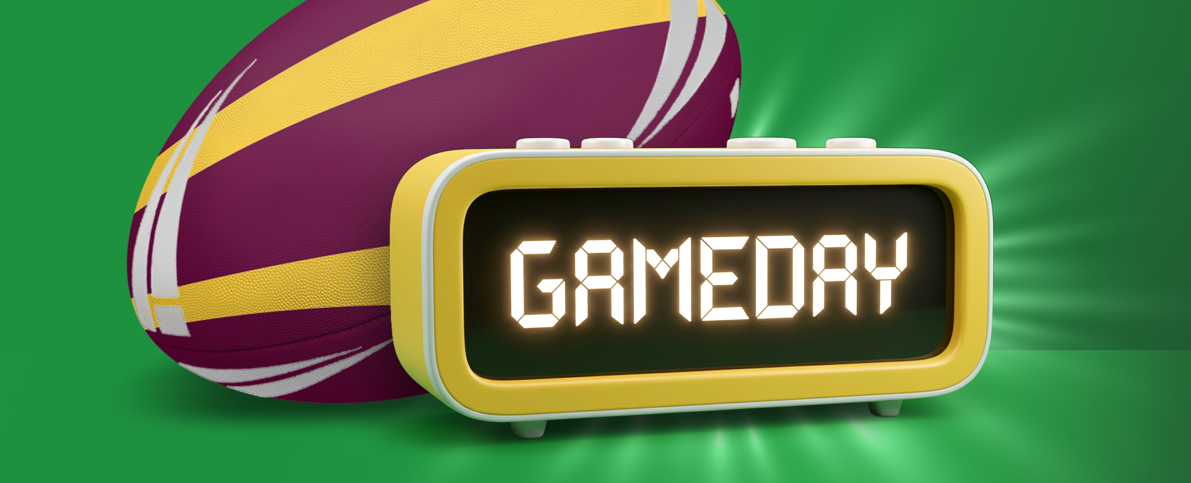 A digital alarm clock displaying the word “GAMEDAY” in glowing letters, placed in front of a maroon and gold rugby ball on a bright green background