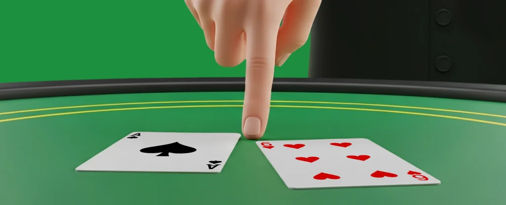 A dealer’s hand points to two playing cards on a green blackjack table, showing an Ace of Spades and a 6 of Hearts.