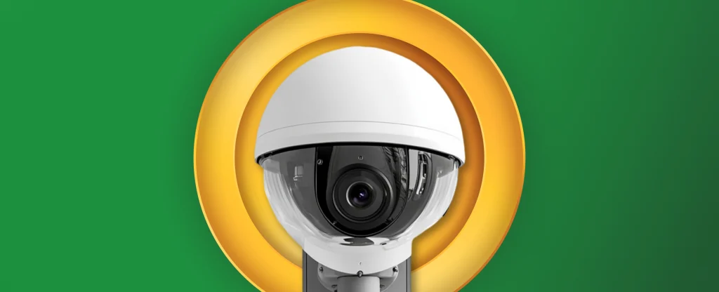 A security style camera is centred on a green background.