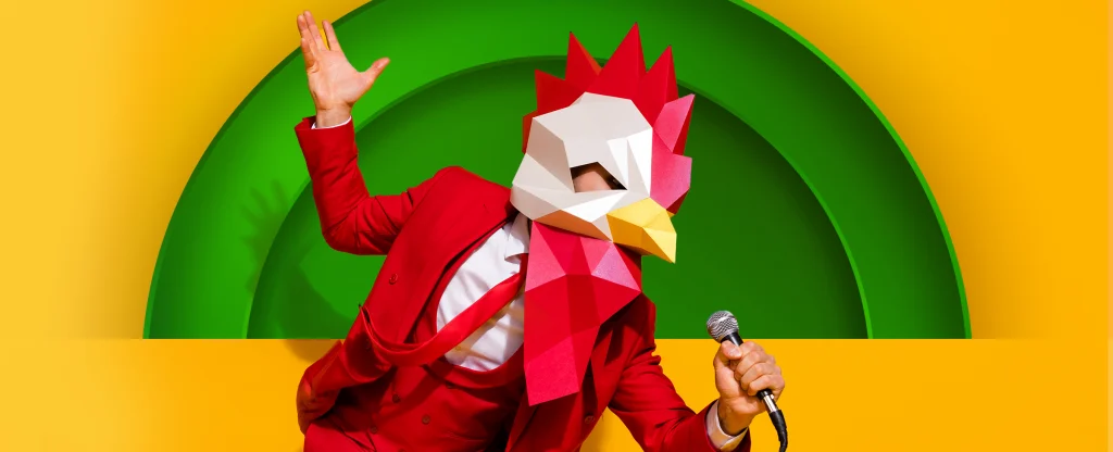 A person with a chicken mask on is singing, depicting ‘The Masked Singer’. On a yellow background.