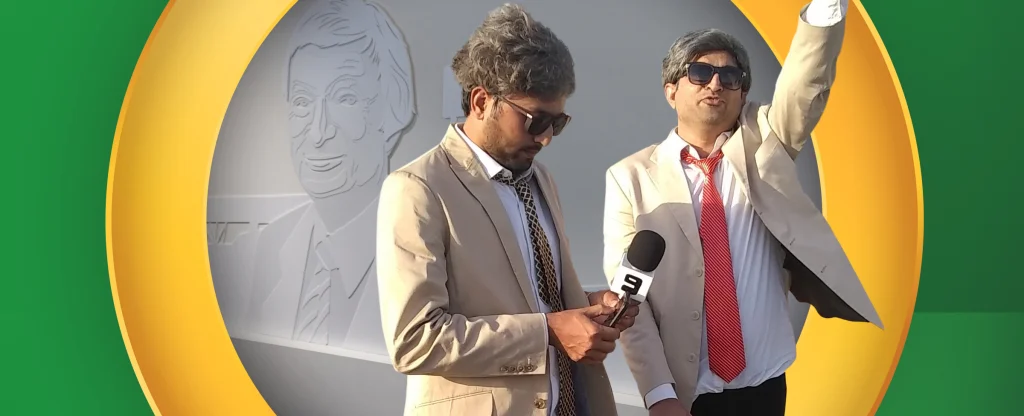 Two men dressed as Richie Benaud impersonators in beige suits and grey wigs stand in front of a wall mural of Benaud, one holding a Channel 9 microphone and the other raising his arm, all framed by a gold oval on a bright green background.